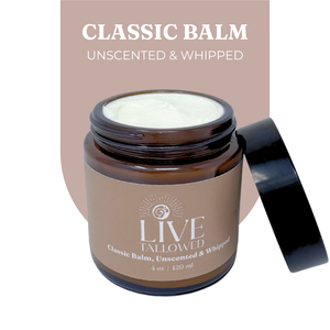 Jar of Live Tallowed Classic Balm, an unscented and whipped tallow balm, displayed with its lid open. The rich, creamy balm is shown with a smooth texture. Label reads 'Classic Balm, Unscented & Whipped' in a 4 oz amber glass jar.