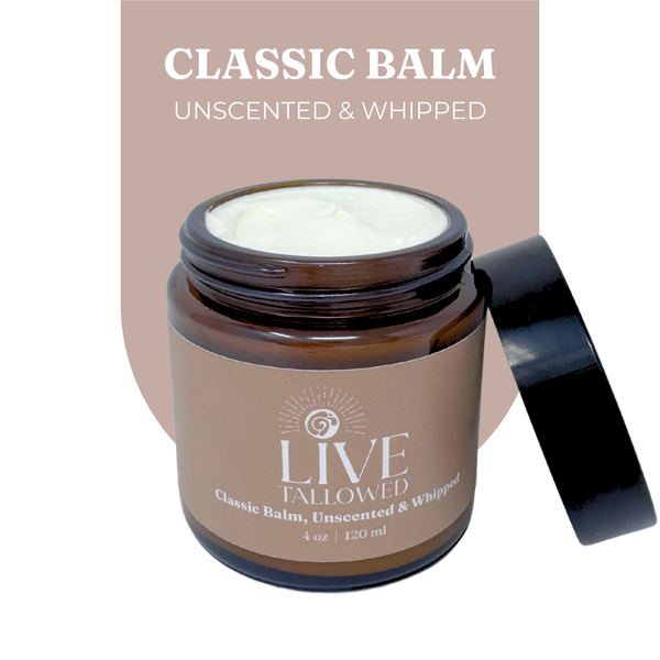 Jar of Live Tallowed Classic Balm, an unscented and whipped tallow balm, displayed with its lid open. The rich, creamy balm is shown with a smooth texture. Label reads 'Classic Balm, Unscented & Whipped' in a 4 oz amber glass jar.