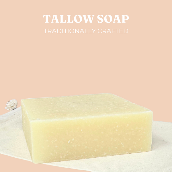 Live Tallowed handcrafted tallow soap bar with a natural, creamy color, resting on a neutral fabric surface. Set against a wooden background, featuring the Live Tallowed logo. A nourishing, all-natural soap for gentle cleansing and hydration.