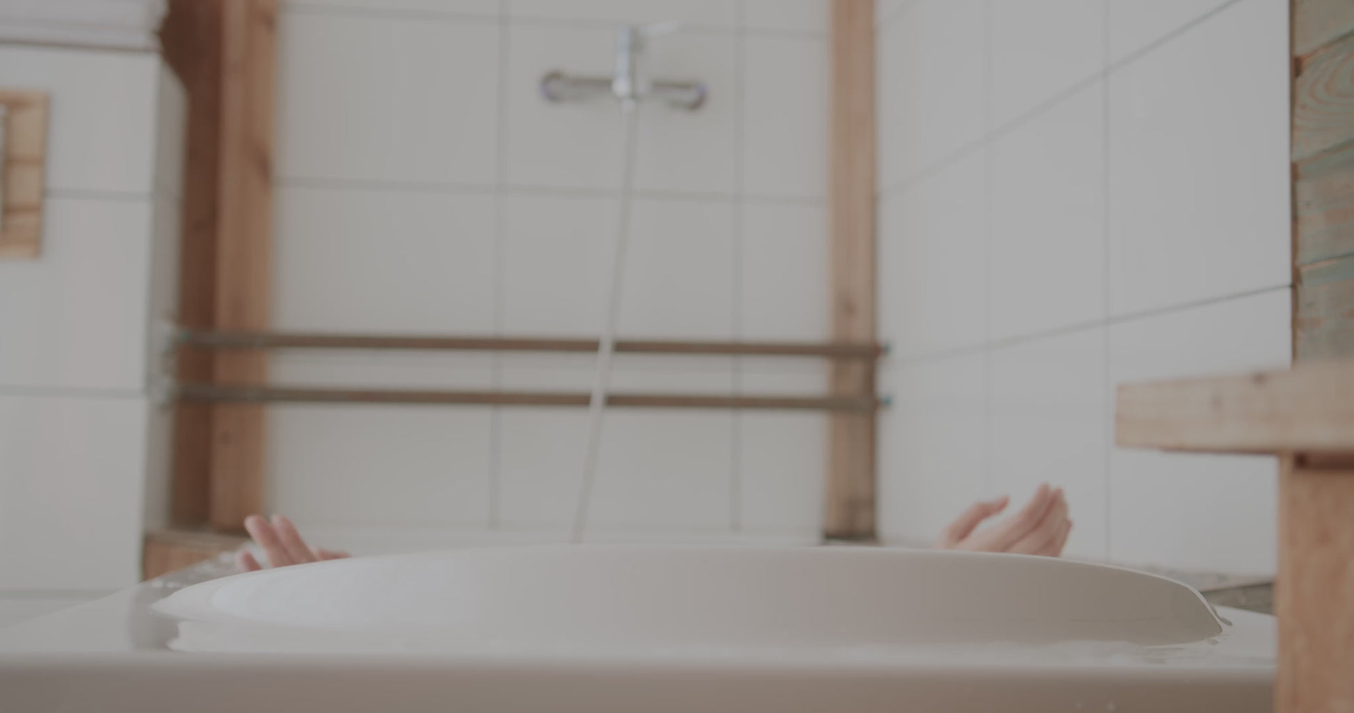 Woman in a soap filled bath using a tallow bar soap, a nourishing, all-natural soap for gentle cleansing and hydration.